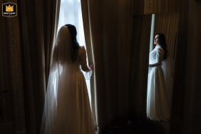   At Columbia Hotel in London, a striking bride portrait showcases her in wedding dress, highlighted by the window light at this classic London venue.